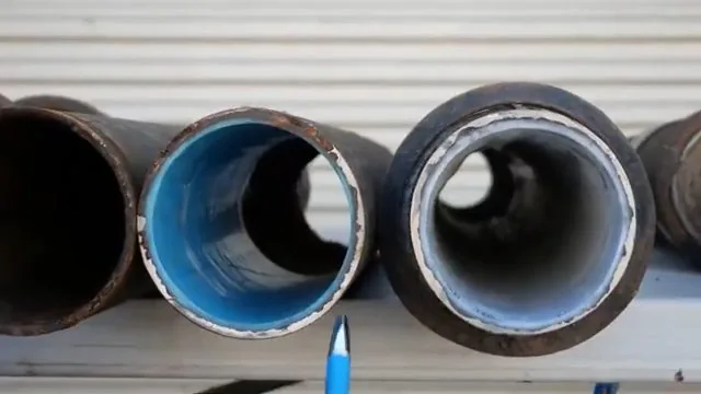 Three iron pipe cross-sections laid side by side, one lined with blue resin