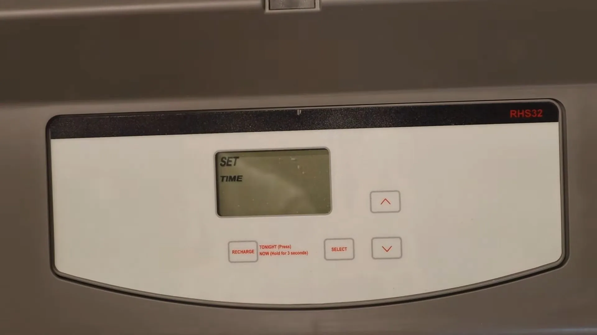 Softener control head showing a set-time display and four buttons